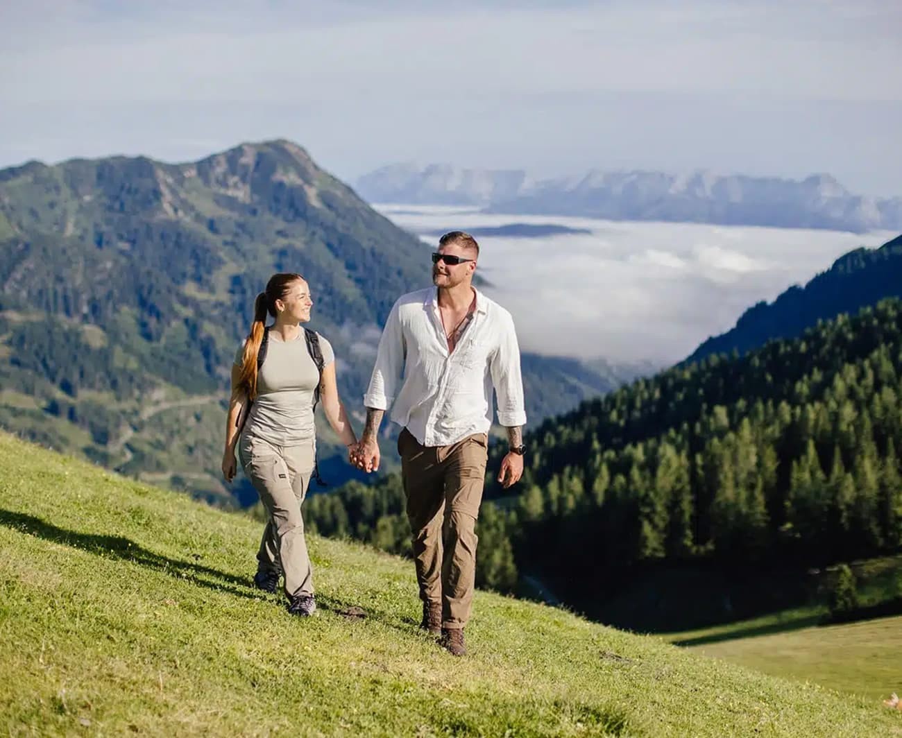Couple walking over green meadows