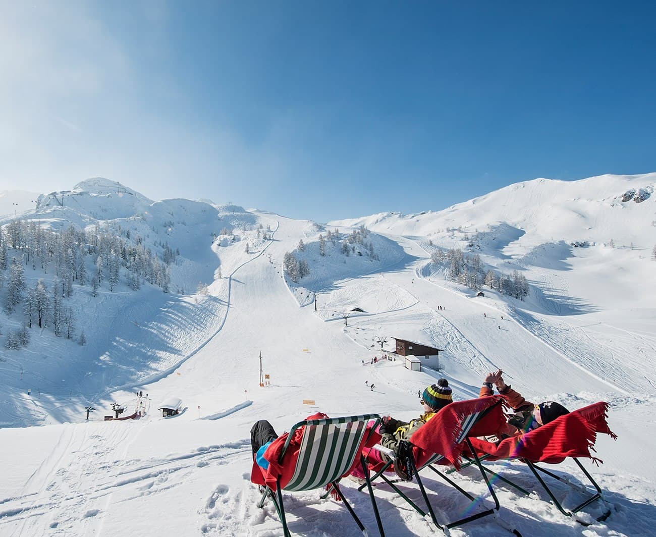 Enjoying holiday pearls skiing in a deck chair in the Zauchensee ski area.